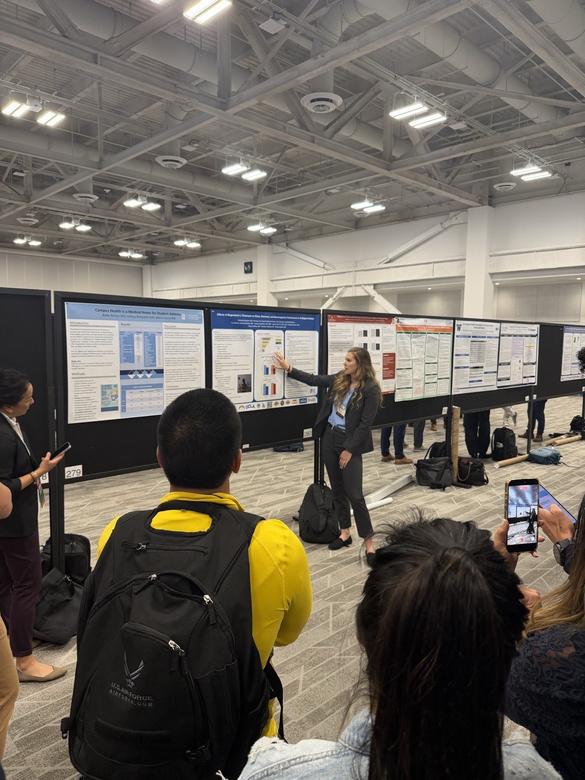 Dr. Kimberly Burbank presenting the Magnesium L-Threonate poster to attendees during the AMSSM 2026 poster session